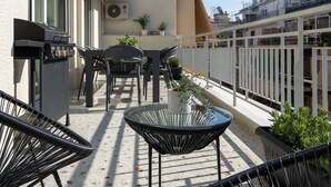 A rooftop terrace with outdoor seating, a barbecue grill, and potted plants. - Deluxe 4 Bedrooms Apartment in Athens Center (Athens)