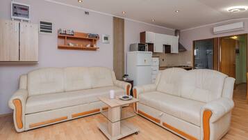 Family Apartment (A3) | Living area | 100-cm flat-screen TV with satellite channels, TV
