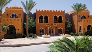 A building with arched windows and a sign reading "Nakheel Family Star". - Makadi Family Star Hotel (Makadi Bay)
