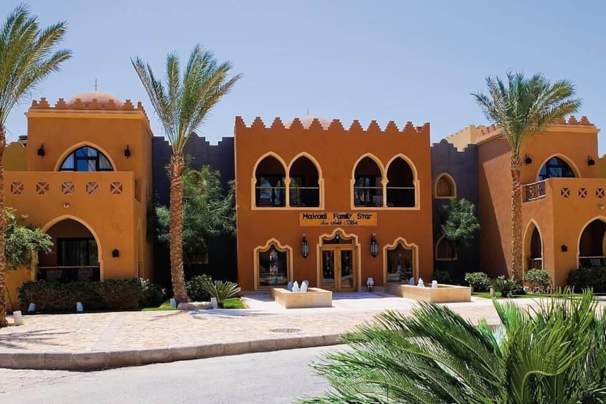 A building with arched windows and a sign reading "Nakheel Family Star".