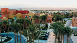 A resort with traditional architecture, palm trees, and a pool area. - Makadi Family Star Hotel (Makadi Bay)