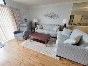 A living room with a sofa set, a coffee table, and two lamps. - Ocean Towers 101 (North Myrtle Beach)