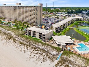 A coastal hotel with multiple buildings, a beach, and a pool area. - Sugar Beach-C16 Unique in the best way. Just updated be first to enjoy upgrades. (Panama City)