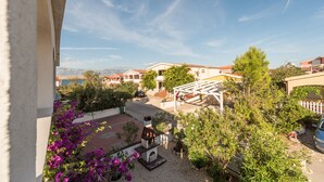 A residential area with a patio, outdoor seating, and a view of neighboring houses. - Apartment Steindl (Vir)