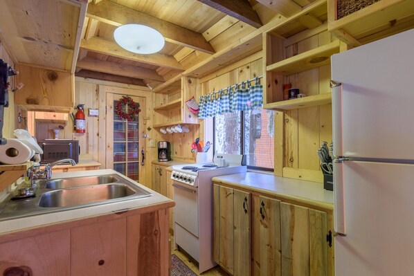 A wooden cabin kitchen with a sink, stove, and refrigerator. - Fall special, stay before 11/03/26 get third night free ! (Government Camp)