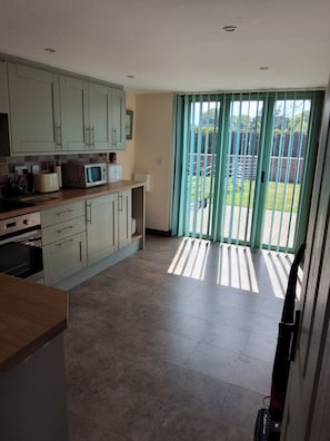 A kitchen with cabinets, a microwave, and a toaster. - Country Views peaceful location in superb setting close to the Norfolk Broads (Loddon)