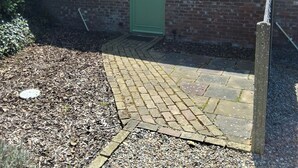 A brick house with a tiled roof, a green door, and two windows. - Country Views peaceful location in superb setting close to the Norfolk Broads (Loddon)