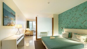 Een moderne hotelkamer met een bed, bureau en stoel, een schilderij aan de muur en uitzicht door de deur.