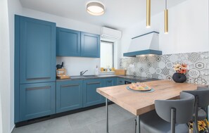 Enjoy cooking in this well-equipped kitchen with an oven, sink, and window above the countertop.