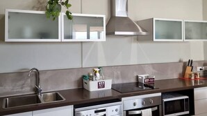 A modern kitchen with stainless steel appliances, a built-in oven, and a dishwasher. - Waverley apartment D-one bedroom, wifi available (Beckenham)