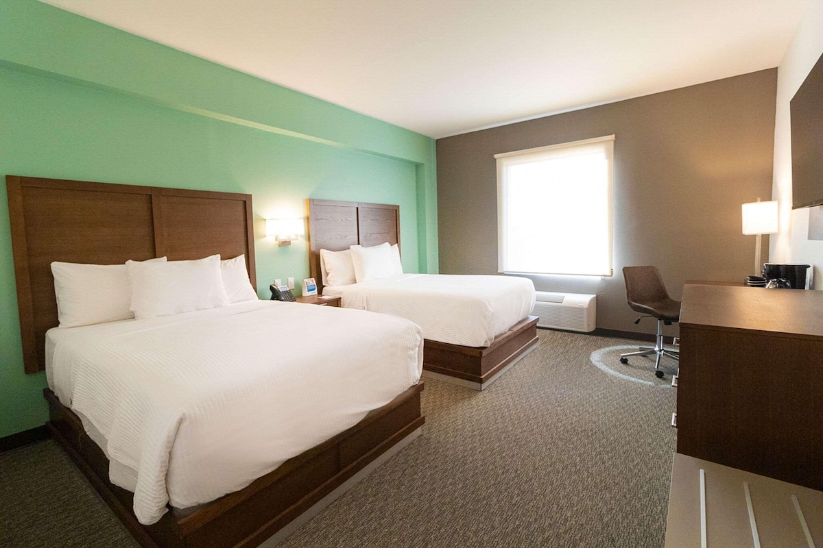 Premium bedding, desk, laptop workspace, blackout drapes