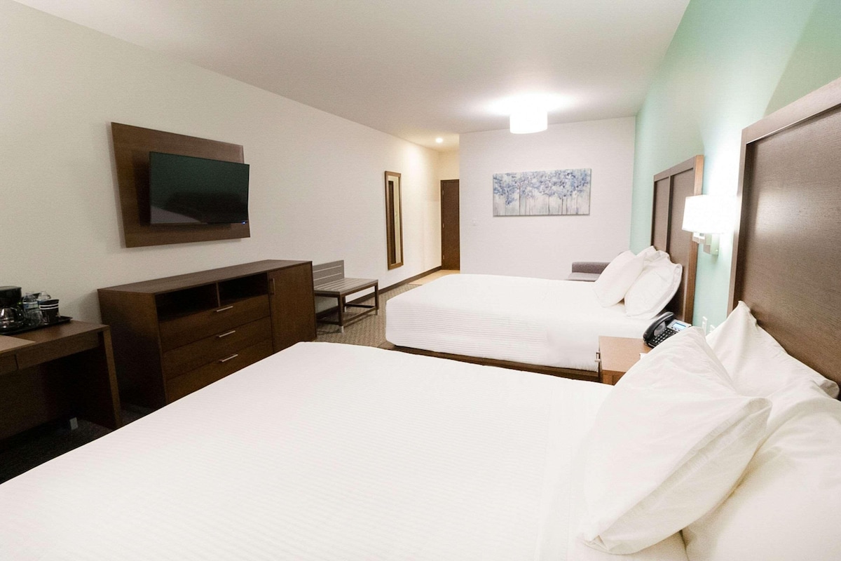 Premium bedding, desk, laptop workspace, blackout drapes