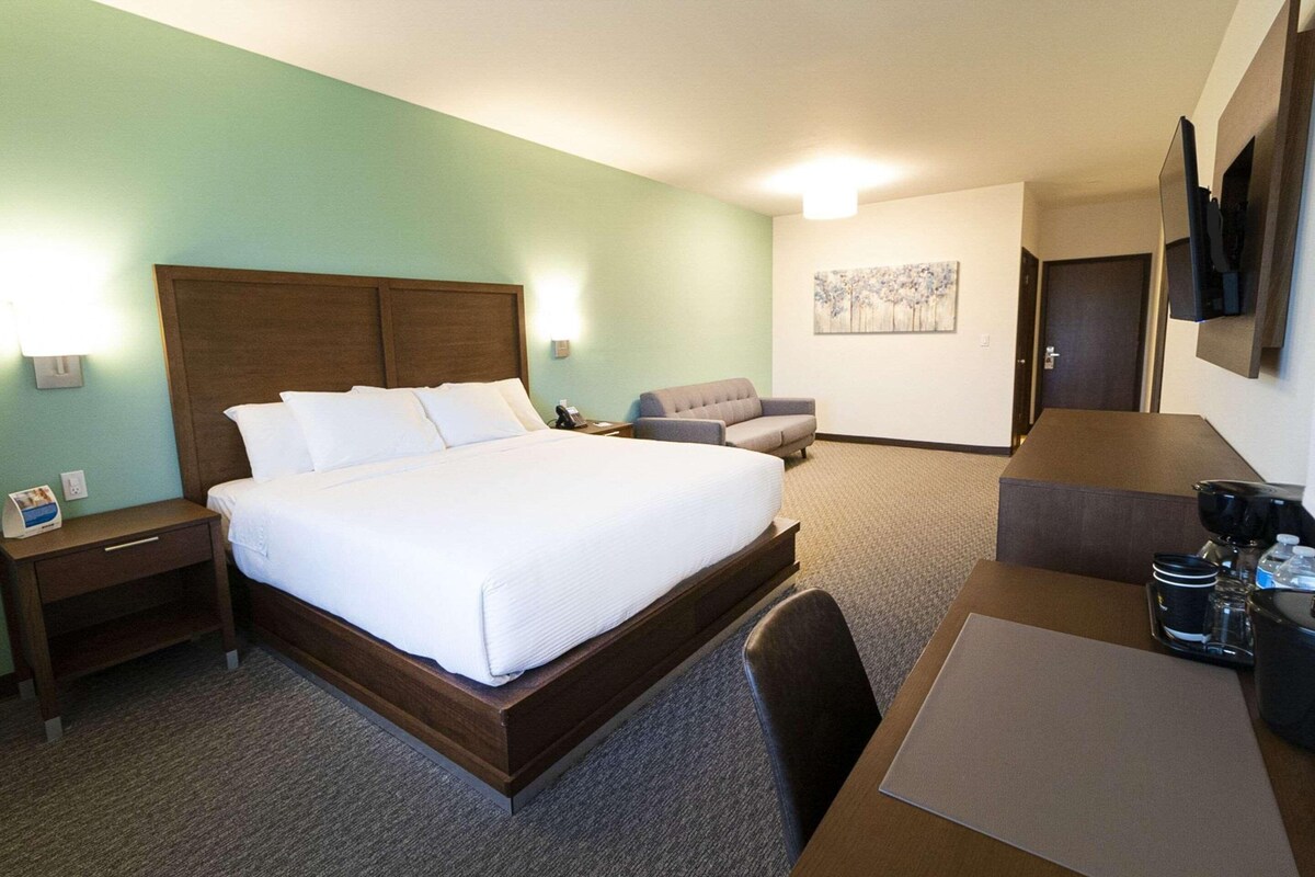 Premium bedding, desk, laptop workspace, blackout drapes