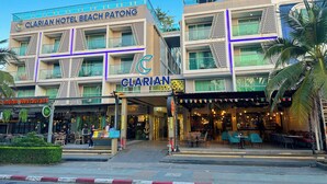 Clarian Hotel Beach Patong with a modern facade, multiple balconies, and an entrance with outdoor seating. - Clarian Hotel Beach Patong (Patong)