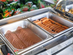 A buffet with two sections of food, one with sliced items and the other with whole items. - Clarian Hotel Beach Patong (Patong)