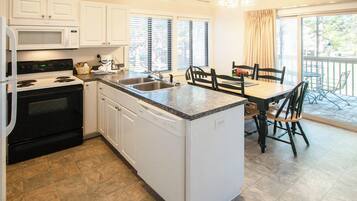 Deluxe Townhome, 2 Bedrooms, Balcony | Private kitchen | Full-sized fridge, microwave, oven, stovetop