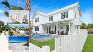 A white two-story house with a covered porch, a swimming pool, and a fenced yard.