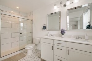 A modern bathroom with a glass shower enclosure, a toilet, a vanity with a mirror, and a sink. - Balcony & Mtn Views! Newly Built Getaway in Monroe (Monroe)