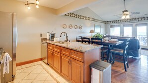A kitchen with wooden cabinets, a granite countertop, and a built-in dishwasher. - 2 Mi to Silver Dollar City: Lakefront Branson Gem! (Branson)