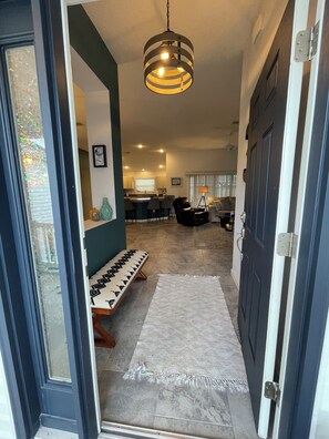 A modern interior with a dining area, kitchen, and living space.