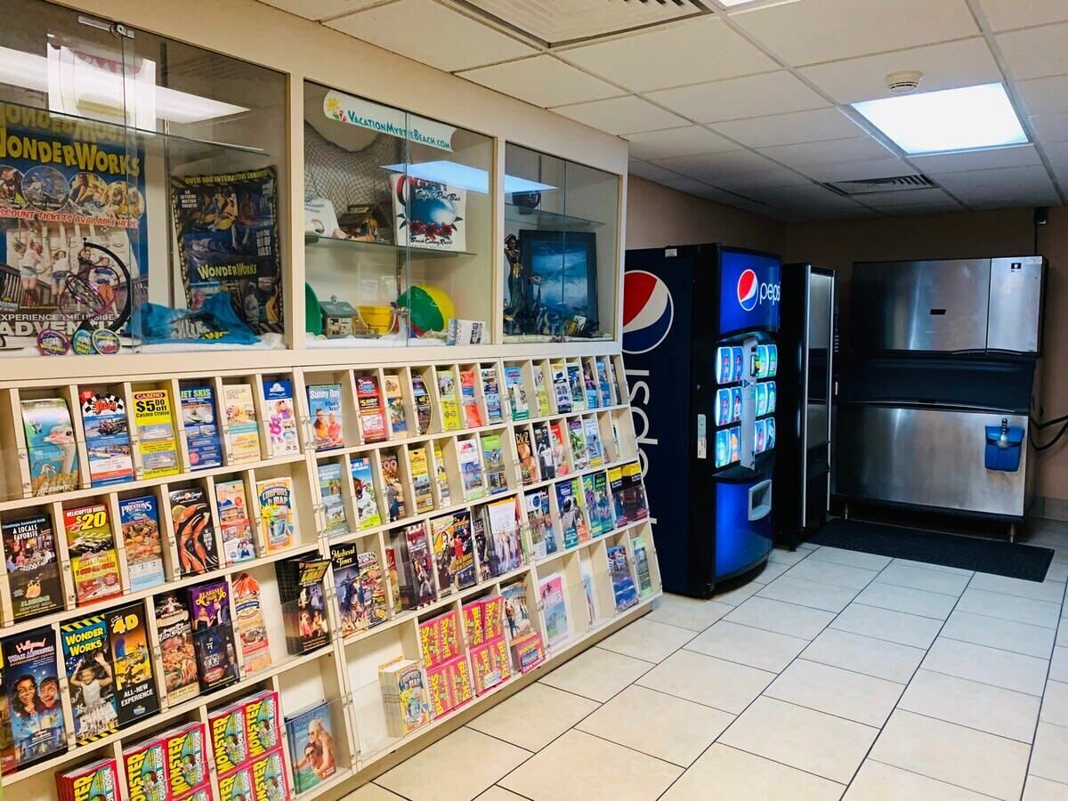 A bookstore with shelves of books, a Pepsi vending machine, and a refrigerator.