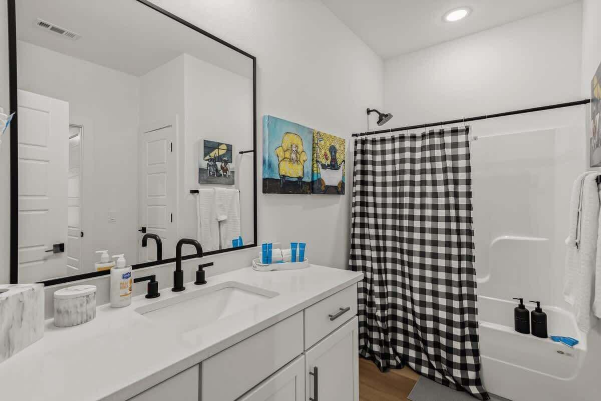 Bathtub, hair dryer, towels, shampoo