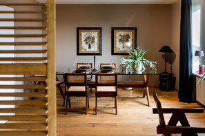 Enjoy meals in this cozy dining area with a glass table and comfortable seating.