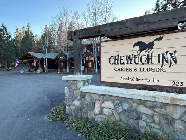 A sign for Chewuch Inn, a bed and breakfast inn with cabins and lodging.