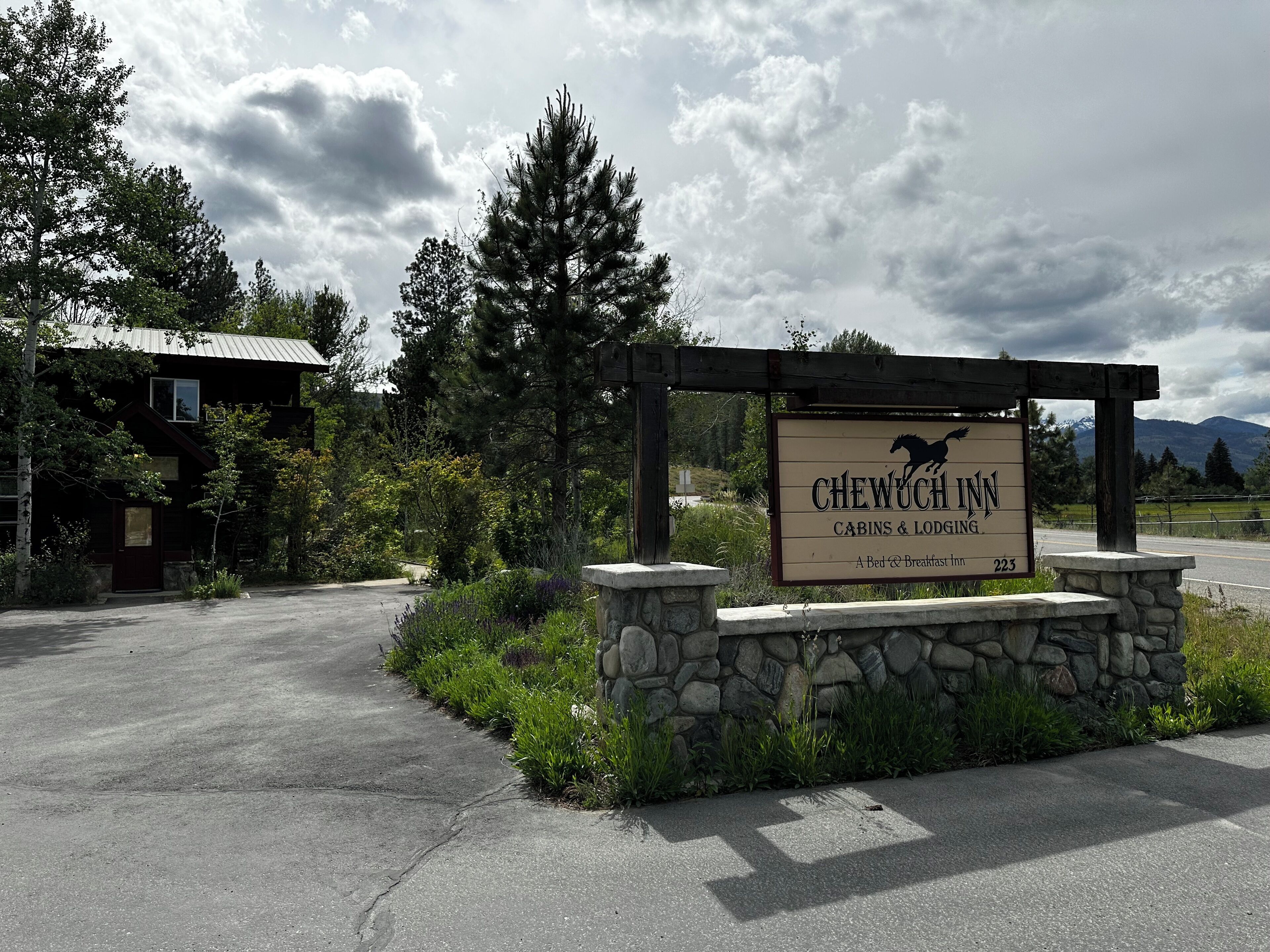 A sign for Chewuch Inn, indicating it offers cabins and lodging with a bed and breakfast service.