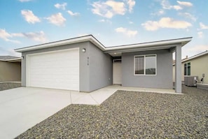 Enjoy a home with a spacious garage, well-maintained driveway, and a front yard.