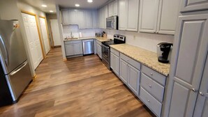 A modern kitchen with light grey cabinets, stainless steel appliances, and a granite countertop. - Lakeside Waterfront: Private Dock - Near Lake Anna Winery (Bumpass)