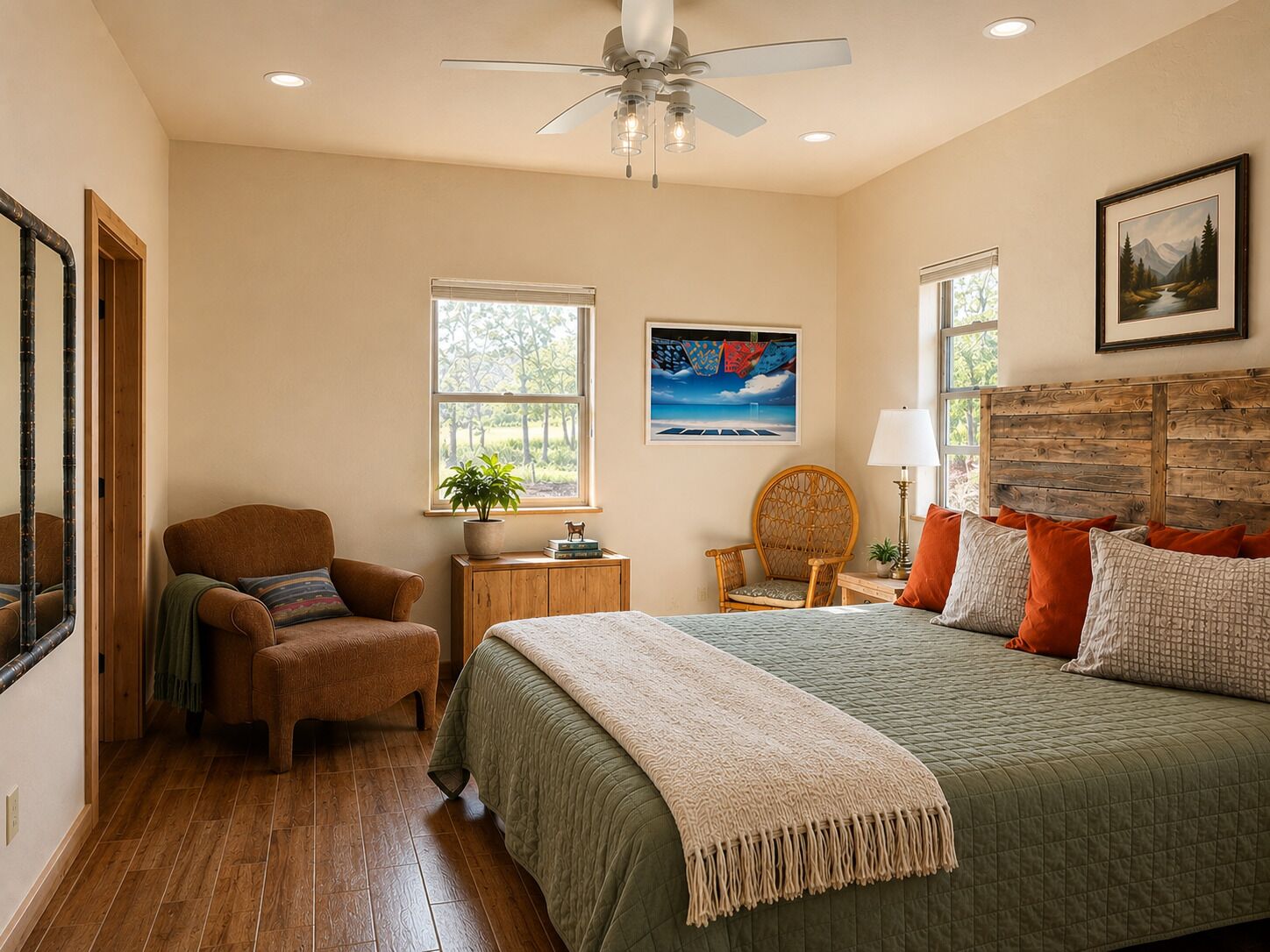 A bedroom with a bed, a chair, a nightstand, a ceiling fan, and two windows.