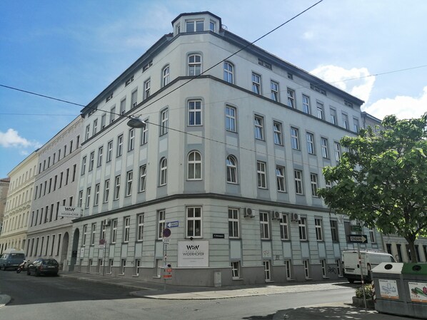 A multi-story building with a prominent 'Widerhofer' sign, indicating a business or commercial use.