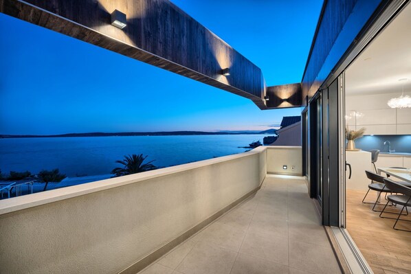 Ein Balkon mit Blick auf das Meer im Abenddämmerung.