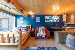Relax in a cozy room with a comfortable bed, plush armchair, and inviting sofa.