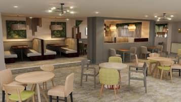 Un intérieur moderne avec des espaces de détente, des tables et un éclairage d’ambiance.