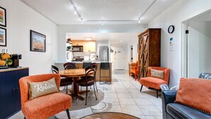 A compact living space with a dining area, kitchen, and seating area.
