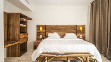 A bedroom with a wooden bed frame, two bedside tables, a built-in wardrobe, and a large window with curtains.