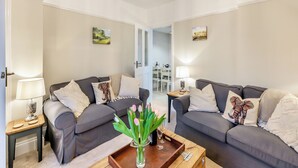 A modern living room with two grey sofas, a wooden coffee table, and a chandelier. - Pennypot Cottage - UK41787 (Kettlewell)
