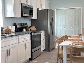Enjoy cooking in this well-equipped kitchen with a dining table and modern appliances.