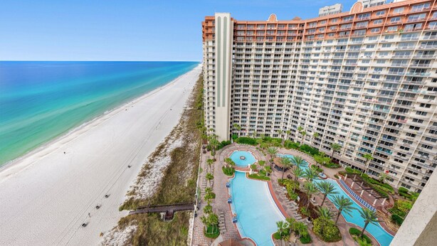A high-rise hotel with a beach view, a swimming pool, and a landscaped garden. - Beachfront Wrap Balcony & Views! Shores of Panama (Panama City Beach)