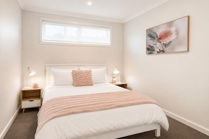 A bedroom with a bed, two bedside tables, a window, and a wall-mounted picture. - Holiday on Dromana by Ready Set Stay- 150m from the beach (Safety Beach)