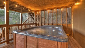 A wooden deck with a hot tub, wooden railings, and a staircase leading to an upper level. - Overlook Oasis - Hot tub, firepit, and comfy king beds! (Blue Ridge)