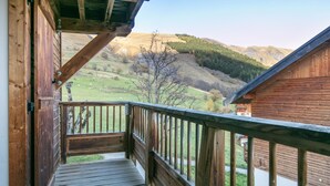 A wooden balcony with a view of a hilly landscape and a body of water. - Spacious apt 7 ppl, mountain view balcony (Saint-Sorlin-d´Arves)
