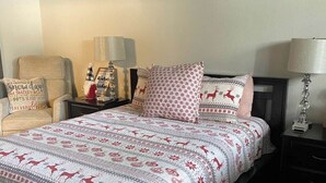 A bedroom with a bed, nightstands, a chair, and star decorations on the wall. - Shaver Escape! Mountain Loft Condo (Shaver Lake)