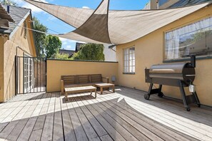 A wooden deck with a barbecue grill, a bench, and a table. - Downtown Retreat w/ Pool & Spa, Near National Parks (Visalia)
