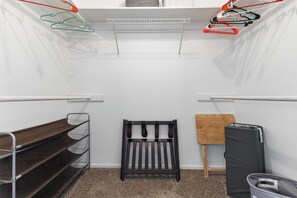 A compact storage unit with shelves, a bench, and a pegboard for hanging items. - Visalia Luxe CA: 3BR w/ Private Pool, BBQ, & Patio (Visalia)