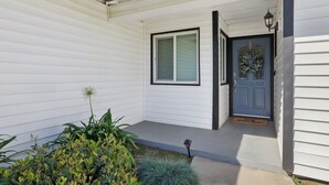 A house with a front door, a window, and a small porch area. - Visalia Luxe CA: 3BR w/ Private Pool, BBQ, & Patio (Visalia)