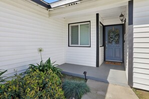 A house with a front door, a window, and a small porch area. - Visalia Luxe CA: 3BR w/ Private Pool, BBQ, & Patio (Visalia)