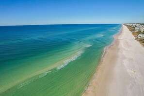 A beach with clear water and a sandy shore. - Surfer Dog 4 Bedroom Home by RedAwning (Panama City Beach)